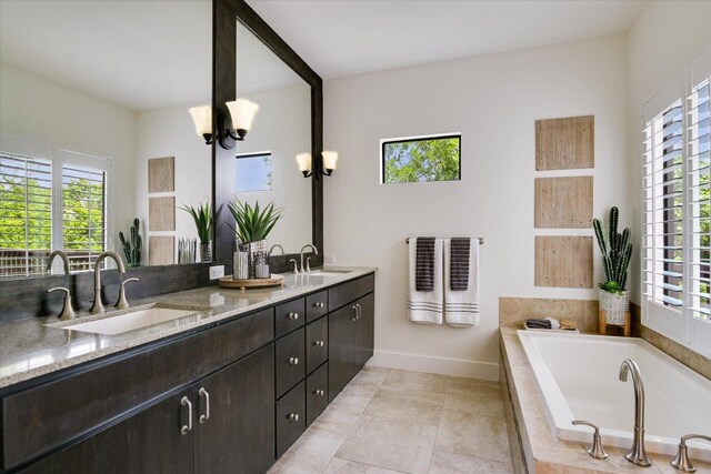 4608 Windy Brook Dr Unit B, Austin, TX 78723 - bathroom featuring healthy amount of natural light, a relaxing tiled tub, double vanity, and baseboards