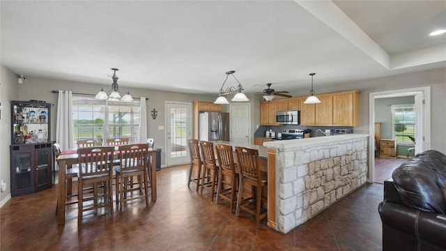 310 Hatter Dr, Moody, TX 76557 - kitchen with stainless steel appliances, light countertops, a peninsula, a chandelier, and ceiling fan