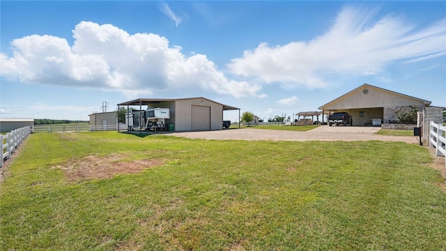 310 Hatter Dr, Moody, TX 76557 - view of yard with driveway, a detached garage, and an outdoor structure