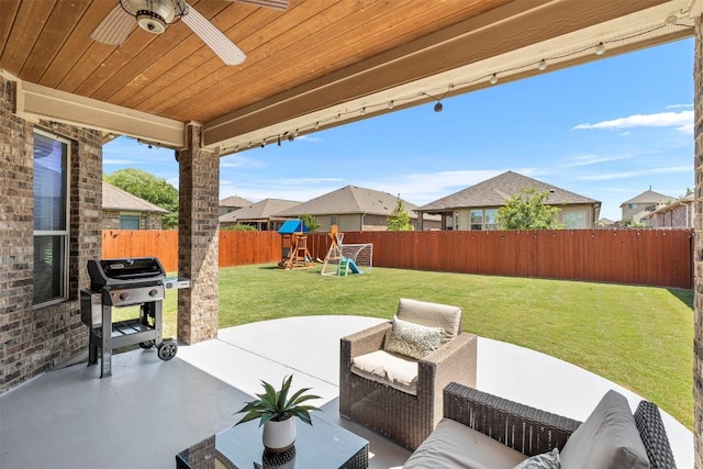 view of patio / terrace with area for grilling, a playground, ceiling fan, and a residential view