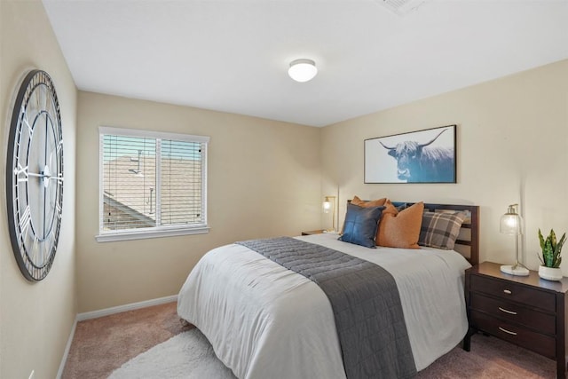 bedroom featuring carpet and baseboards