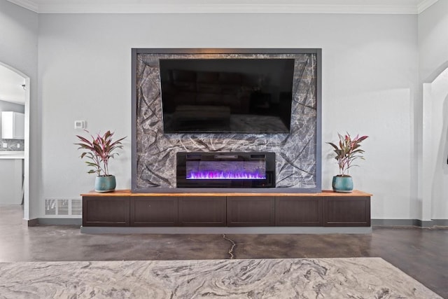 407 Osman Dr, Killeen, TX 76542 - living room featuring finished concrete flooring, crown molding, a premium fireplace, arched walkways, and baseboards