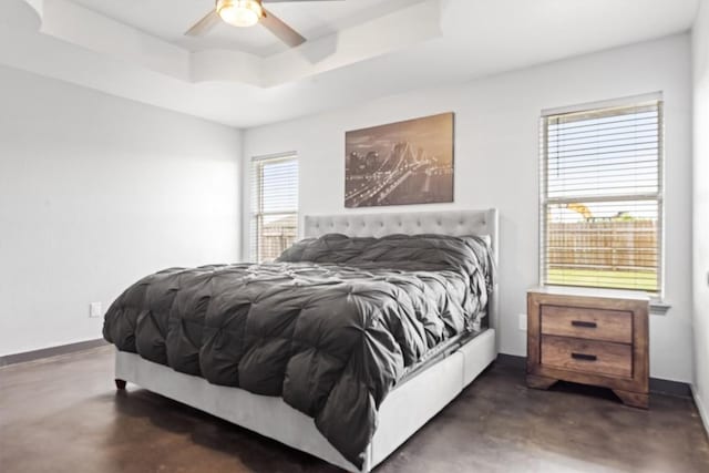 407 Osman Dr, Killeen, TX 76542 - bedroom with concrete flooring, a tray ceiling, baseboards, and a ceiling fan
