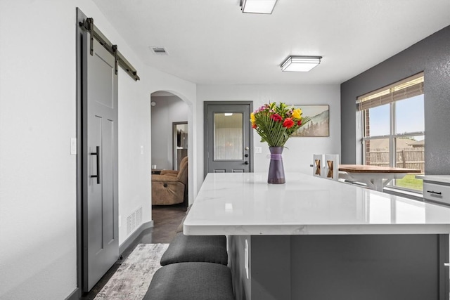 407 Osman Dr, Killeen, TX 76542 - kitchen featuring light countertops, arched walkways, a center island, and baseboards