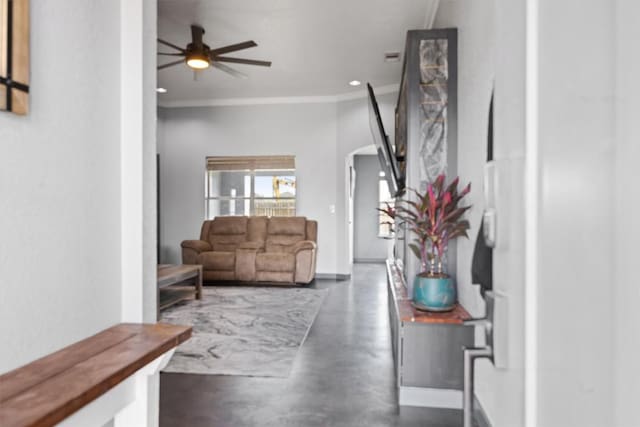 407 Osman Dr, Killeen, TX 76542 - living room featuring concrete floors, arched walkways, ornamental molding, a ceiling fan, and baseboards