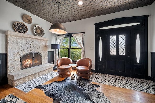 234 Loring, Stonewall, TX 78671 - foyer with wood finished floors, an ornate ceiling, and a fireplace