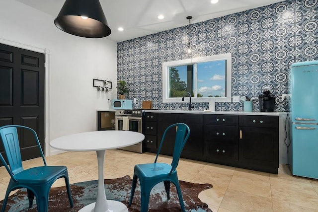 234 Loring, Stonewall, TX 78671 - kitchen featuring dark cabinets, white microwave, recessed lighting, refrigerator, and stainless steel range with electric cooktop