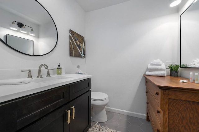 234 Loring, Stonewall, TX 78671 - bathroom featuring vanity, toilet, baseboards, and tile patterned flooring