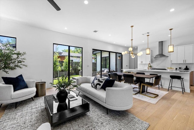 5409 Ave G Ave, Austin, TX 78751 - living room with light wood finished floors, recessed lighting, and a chandelier