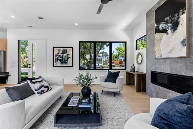 5409 Ave G Ave, Austin, TX 78751 - living area featuring light wood finished floors, plenty of natural light, ceiling fan, recessed lighting, and a premium fireplace