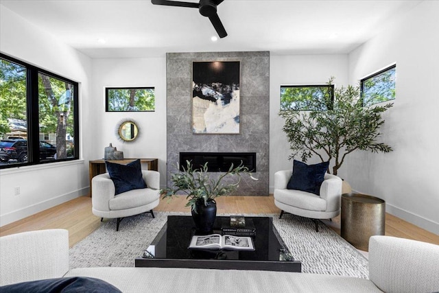 5409 Ave G Ave, Austin, TX 78751 - living area featuring a tiled fireplace, wood finished floors, a ceiling fan, and recessed lighting