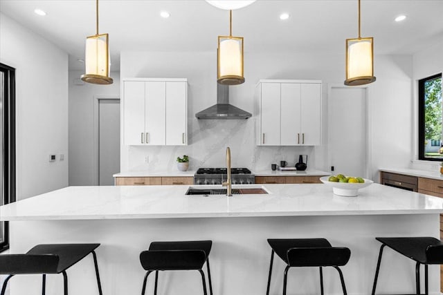 5409 Ave G Ave, Austin, TX 78751 - kitchen with a sink, tasteful backsplash, recessed lighting, white cabinetry, and a large island