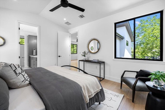 5409 Ave G Ave, Austin, TX 78751 - bedroom with light wood finished floors, lofted ceiling, ceiling fan, baseboards, and connected bathroom