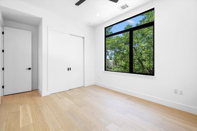 5409 Ave G Ave, Austin, TX 78751 - unfurnished bedroom with light wood-style floors, baseboards, and a ceiling fan