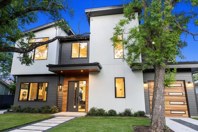 5409 Ave G Ave, Austin, TX 78751 - contemporary home featuring a front yard, stucco siding, and a garage