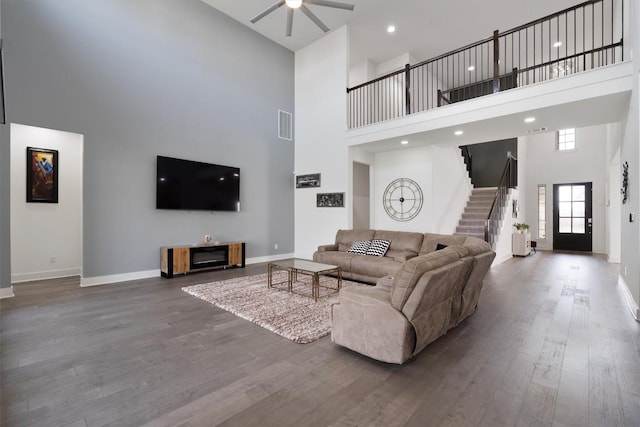 4916 Risana Bnd, Round Rock, TX 78665 - living room with a high ceiling, ceiling fan, baseboards, wood finished floors, and stairs