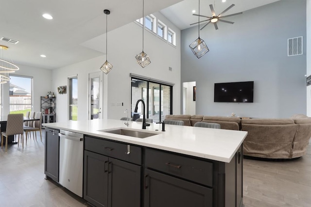 4916 Risana Bnd, Round Rock, TX 78665 - kitchen featuring stainless steel dishwasher, a sink, open floor plan, healthy amount of natural light, and recessed lighting