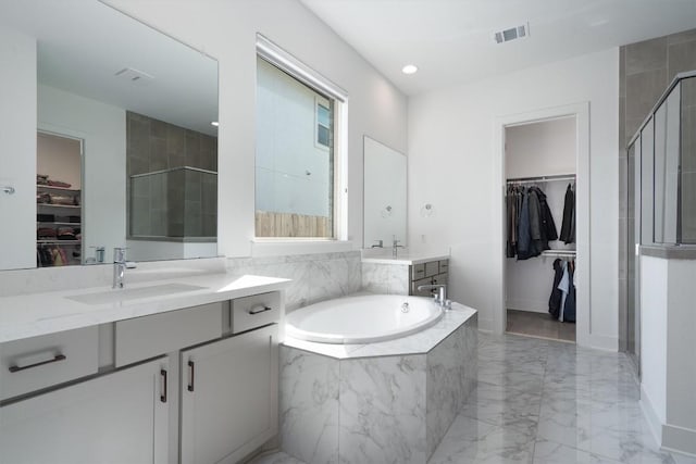 4916 Risana Bnd, Round Rock, TX 78665 - bathroom featuring a stall shower, marble tiled floors, a bath, baseboards, and two vanities