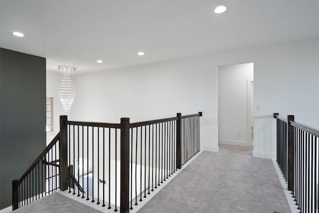 4916 Risana Bnd, Round Rock, TX 78665 - hall with an upstairs landing, a chandelier, recessed lighting, carpet, and baseboards
