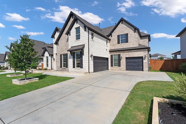 4916 Risana Bnd, Round Rock, TX 78665 - view of front of home featuring driveway, an attached garage, stone siding, and brick siding