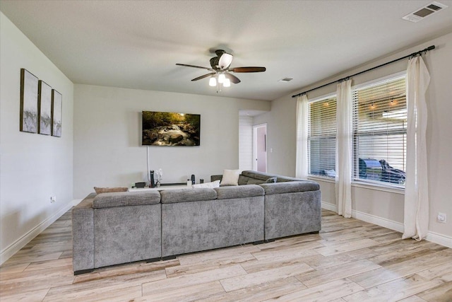 5659 Corsica Loop, Round Rock, TX 78665 - living area with ceiling fan, light wood finished floors, and baseboards