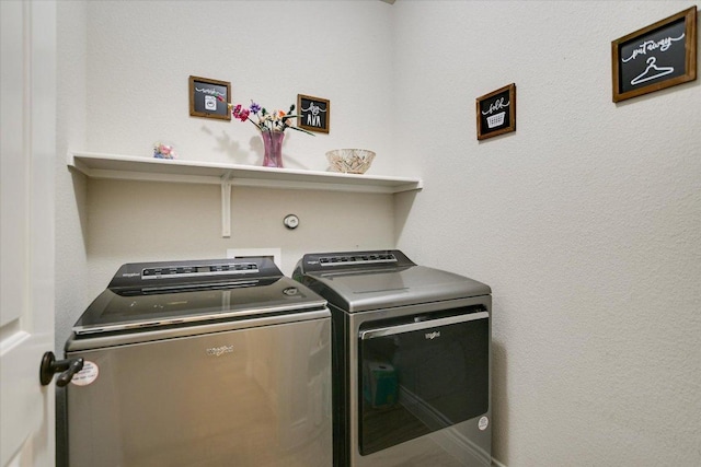clothes washing area with washer and clothes dryer