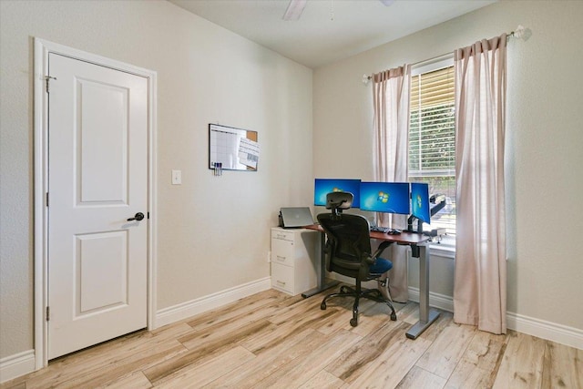 office featuring light wood-style floors, baseboards, and ceiling fan