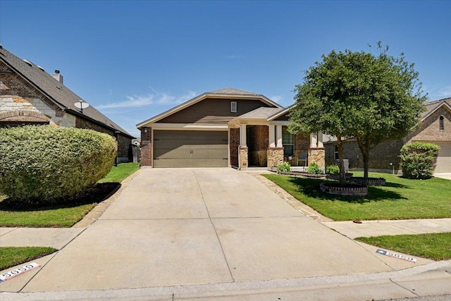 view of front facade featuring an attached garage, concrete driveway, a front lawn, and brick siding