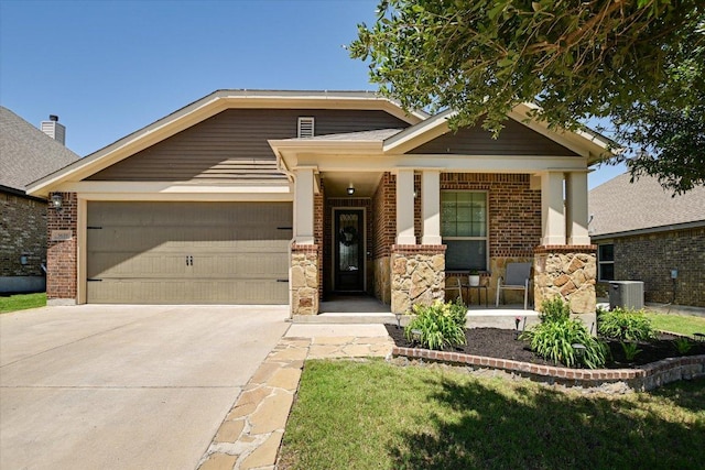 view of front of home featuring brick siding, an attached garage, driveway, covered porch, and central air condition unit