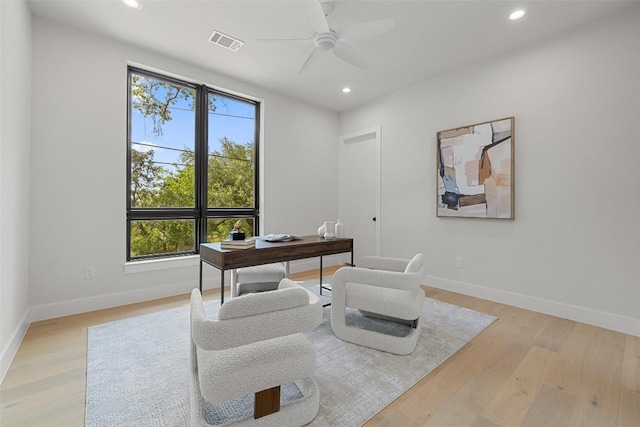 office space featuring recessed lighting, baseboards, a ceiling fan, and light wood-style floors