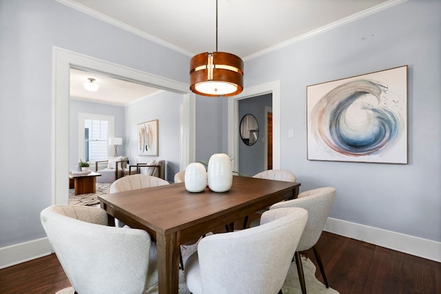 dining space with baseboards, ornamental molding, and dark wood finished floors