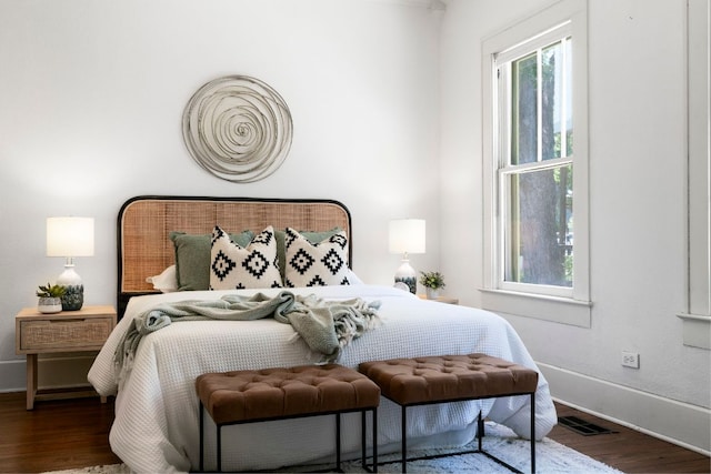 bedroom featuring wood finished floors and baseboards