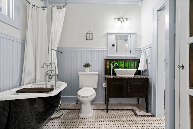 4536 Duval St Unit 2, Austin, TX 78751 - full bath with vanity, a wainscoted wall, and toilet