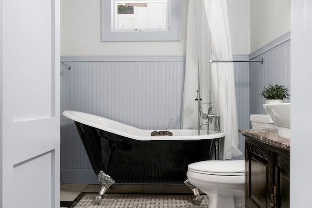 4536 Duval St Unit 2, Austin, TX 78751 - bathroom featuring a wainscoted wall, a freestanding tub, toilet, and vanity