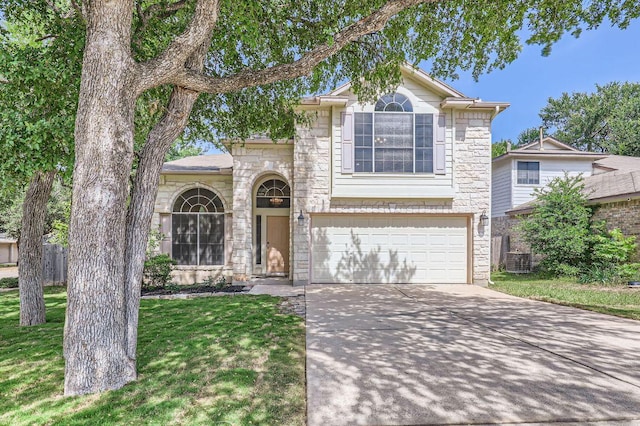 10517 S Canoa Hills Trl, Austin, TX 78717 - traditional-style house featuring stone siding, concrete driveway, a garage, a front lawn, and central AC