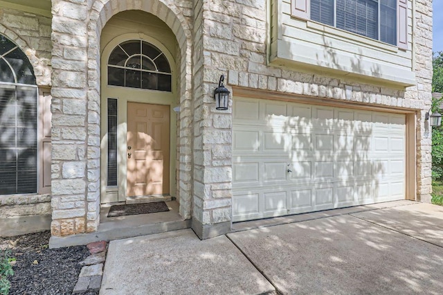 10517 S Canoa Hills Trl, Austin, TX 78717 - entrance to property featuring stone siding, a garage, and driveway