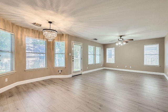 10517 S Canoa Hills Trl, Austin, TX 78717 - spare room featuring a chandelier, ceiling fan, wood finished floors, and healthy amount of natural light