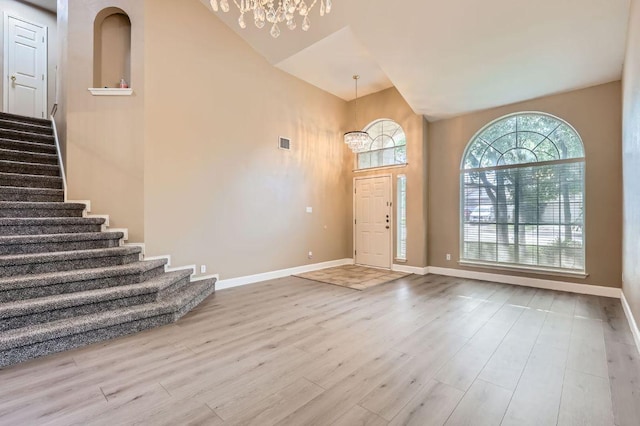 10517 S Canoa Hills Trl, Austin, TX 78717 - entrance foyer featuring a chandelier, wood finished floors, high vaulted ceiling, stairs, and baseboards
