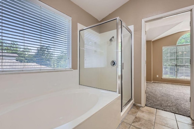 10517 S Canoa Hills Trl, Austin, TX 78717 - full bath featuring lofted ceiling, a bath, a shower stall, and tile patterned floors