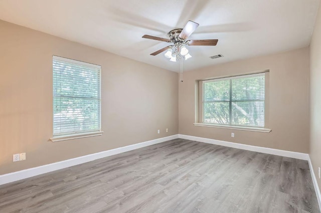 10517 S Canoa Hills Trl, Austin, TX 78717 - empty room with plenty of natural light, ceiling fan, and wood finished floors