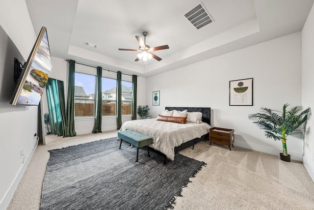 124 Low River Ln, Georgetown, TX 78628 - carpeted bedroom with a raised ceiling, baseboards, and ceiling fan