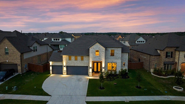 124 Low River Ln, Georgetown, TX 78628 - french country inspired facade with stone siding, a residential view, driveway, and a garage