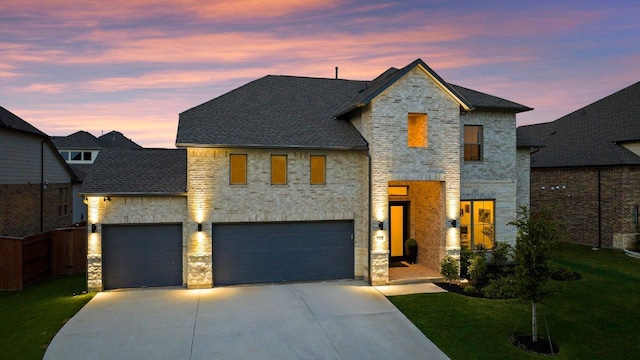 124 Low River Ln, Georgetown, TX 78628 - view of front of house featuring driveway, a yard, roof with shingles, stone siding, and a garage
