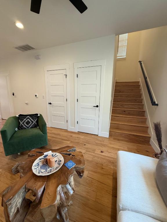 living area with light wood finished floors, stairs, ceiling fan, baseboards, and recessed lighting