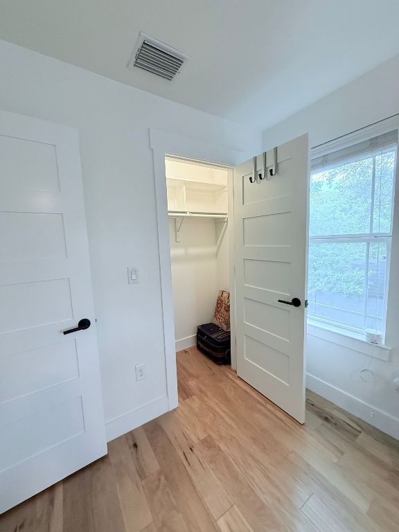 806 Philco Dr Unit 2, Austin, TX 78745 - unfurnished bedroom featuring light wood-style floors, baseboards, and a closet
