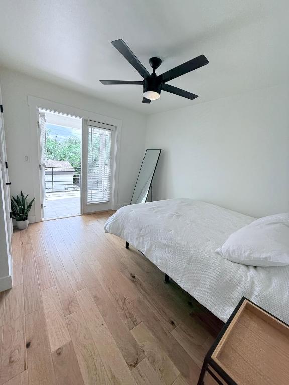 806 Philco Dr Unit 2, Austin, TX 78745 - bedroom featuring access to exterior, wood finished floors, and a ceiling fan