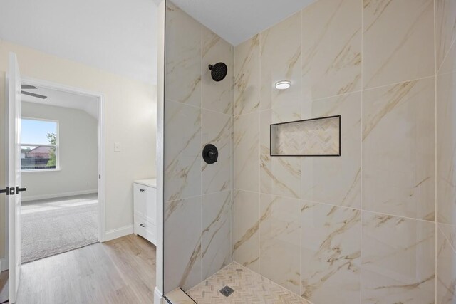 13221 Cabinet Dr, Manor, TX 78653 - bathroom with tiled shower, wood finished floors, and vanity