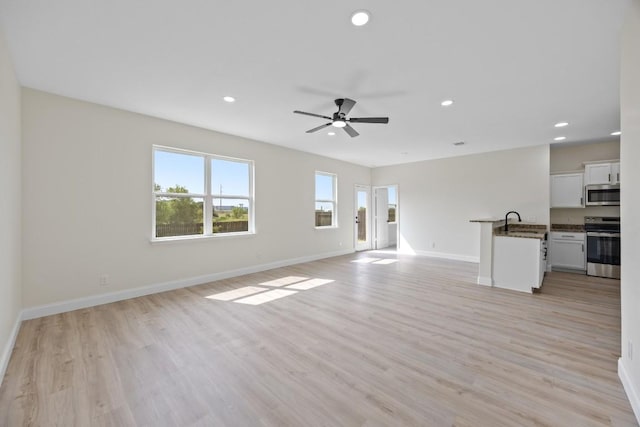 13221 Cabinet Dr, Manor, TX 78653 - unfurnished living room featuring ceiling fan, recessed lighting, and light wood-style flooring