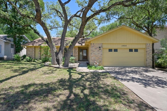 12025 Wycliff Ln, Austin, TX 78727 - ranch-style house with brick siding, an attached garage, a front yard, and driveway