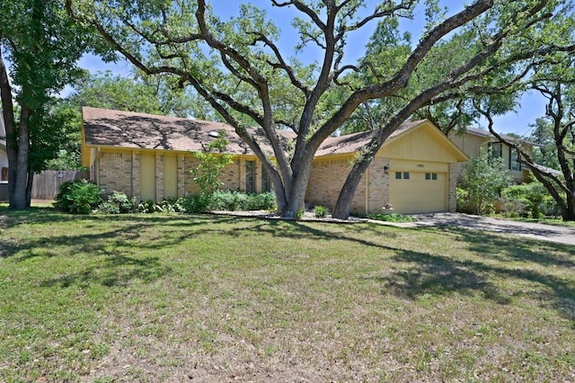 12025 Wycliff Ln, Austin, TX 78727 - view of front of property featuring brick siding, a garage, and driveway